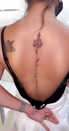 a woman with a tattoo on her back