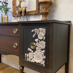 an old dresser with flowers painted on it