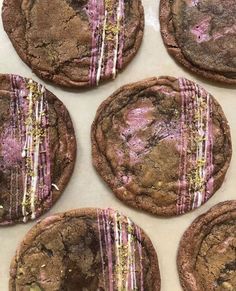 chocolate cookies with pink and white icing on them