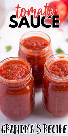 three jars filled with tomato sauce sitting on top of a table