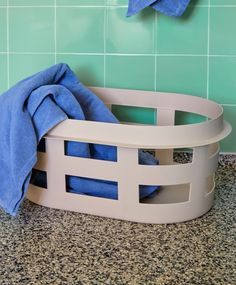 a blue towel is sitting in a white basket