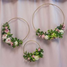 three hoop earrings decorated with flowers and greenery