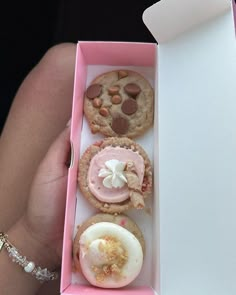 an open pink box filled with assorted pastries