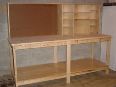 two wooden shelves sitting next to each other on top of a hard wood floor in front of a brick wall