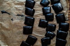 several pieces of chocolate sitting on top of a piece of parchment paper