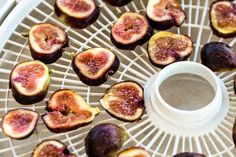 figs are arranged on a wire rack with a white cup