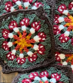 four crocheted coasters are arranged on a wooden surface