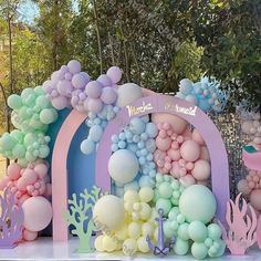 there are balloons and other decorations on the table for a mermaid themed birthday party or baby shower