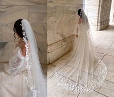 a woman in a wedding dress and veil standing next to a stone wall with flowers on it