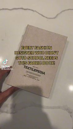 someone is holding up a book with the words, every fashion designer who didn't go school needs this fabric box