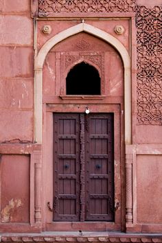 an old building with two wooden doors