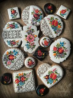 decorated cookies are arranged on a table with doily and other decorative items in the shape of hearts