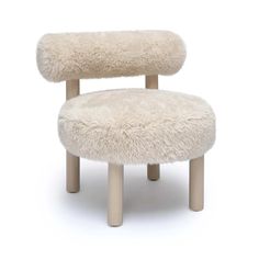 a white chair with a sheepskin seat and foot rest on top of the legs