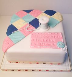 a birthday cake with a sewing kit on top