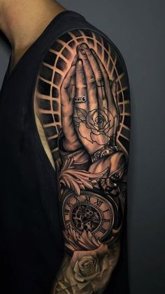 a man's arm with a clock and roses on it, while he is holding his hands in the air