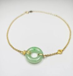 Beautiful translucent light green 'Donut' on 18 karat Gold bracelet. Crafted in 18 karat gold, this traditional bracelet showcases a light green 'Donut' adorned with ancient coin in matt finishes. Sweet apple green stratus interweaves and contrasts with the light green base of the jadeite piece.  Green jadeite is rare and very beautiful. It symbolizes longevity and prosperity.  Treat yourself or surprised her with this masterpiece! Size          : 14 x 3.8 mm (donut) Length     : 19 cm (bracelet Traditional Bracelet, Green Donut, 18k Gold Bracelet, Ancient Coin, Classic Bracelets, Ancient Coins, Jade Jewelry, Our Legacy, Apple Green