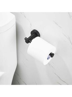 a black and white toilet paper holder next to a roll of toilet paper on the wall