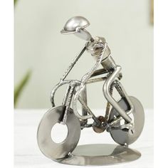 a metal sculpture of a person riding a bike