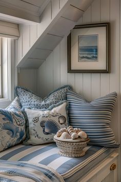 a basket filled with seashells on top of a bench next to a window