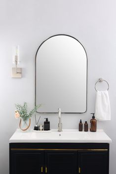 a bathroom vanity with a large mirror above it