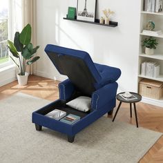 a living room with a blue chair and ottoman