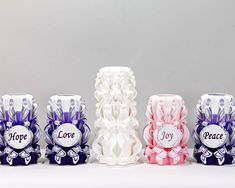 five vases with different designs on them sitting in front of a gray background and the words hope, love, joy