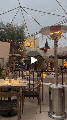 an outdoor dining area with tables and chairs