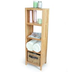 a bamboo shelf with towels and other items on the top, in front of a white background