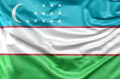 the flag of uzbekistan is waving in the wind