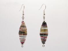 Contemporary black and multicolor stripe tapered paper bead dangle earrings.  Made from Japanese chiyogami paper beautiful metallic gold accents.    Metal beads with  925 sterling silver ear wires complete the look.   The paper beads are hand rolled and glazed with a glossy, translucent coating which hardens and protects them but does not make them waterproof.  Do not swim or shower while wearing them.  Each bead is made from scratch and due to the nature of the process, NO two beads will be the same.  These  earrings are as unique as you are!    Your friends will be SO surprised to find out you are wearing PAPER earrings!  Free shipping. These call to mind the Victorian women who began  in the 1700s making paper beads from wallpaper and rolling it on their knitting needles, ultimately cre Paper Beads Earrings, Chiyogami Paper, Bead Dangle Earrings, Paper Earrings, Beaded Curtains, Beads Earrings, Victorian Women, Paper Beads, Beaded Dangle Earrings