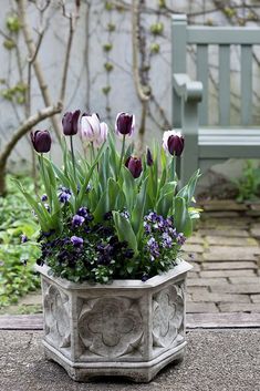 a planter filled with purple and white flowers