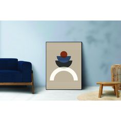 a blue chair sitting next to a painting on the wall