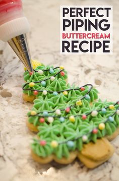 a cookie decorated with green icing and sprinkles is being piped into the shape of a christmas tree