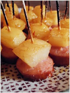 pineapple and ham bites with toothpicks on a plate