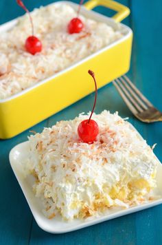 a piece of cake with coconut and cherries on top