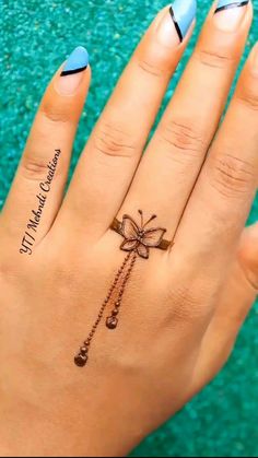 a woman's hand with a bow tattoo on it