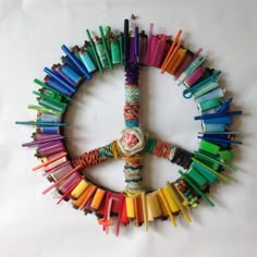 a peace sign made out of colorful crayons