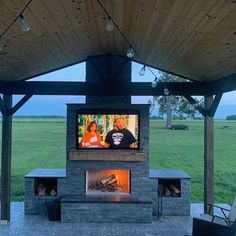 an outdoor fireplace with a television on it