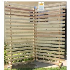 a wooden privacy screen in the grass