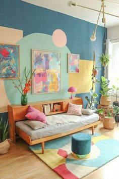 a living room filled with lots of furniture and colorful paintings on the wall above it