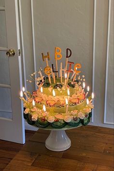 a birthday cake with lit candles on it