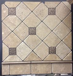 a white tile backsplash with an intricate design