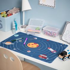 a child's desk with toy cars and toys on it