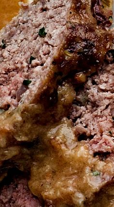 meatloaf on a plate with gravy and parsley