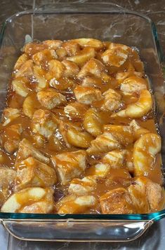 a glass casserole dish filled with bananas and caramel sauce