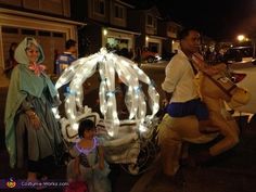 two people and a child are dressed up in costumes