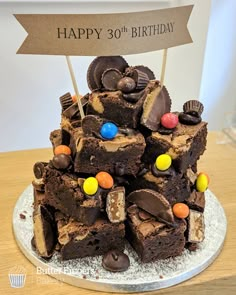 a birthday cake made to look like a pile of brownies