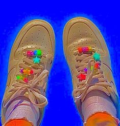 a pair of sneakers with colorful beads on them