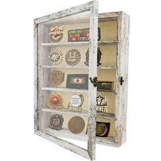 an old wooden display case filled with lots of different types of buttons and magnets