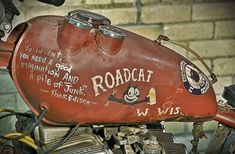 a red tank on the back of a motorcycle